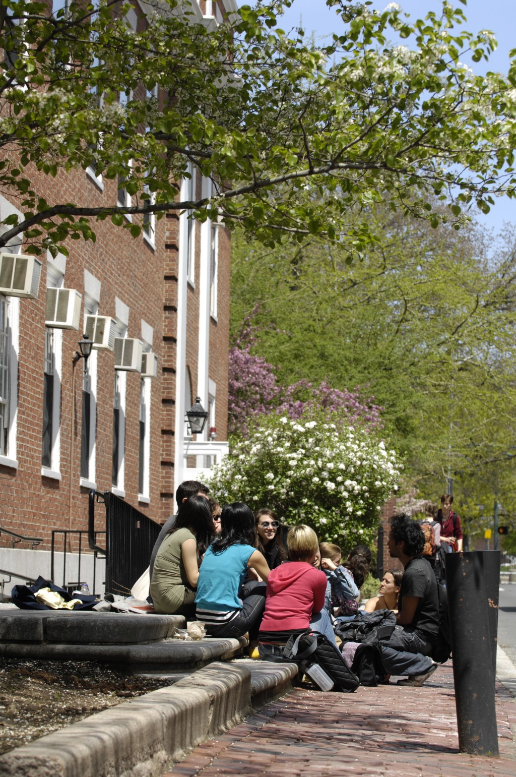 Students sit and talk outside of Longfellow Hall