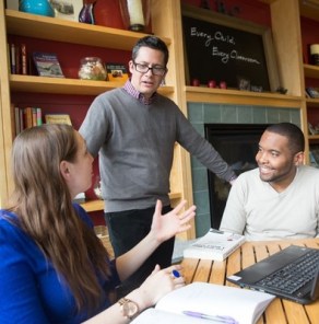 A Professor chatting with students in Gutman library